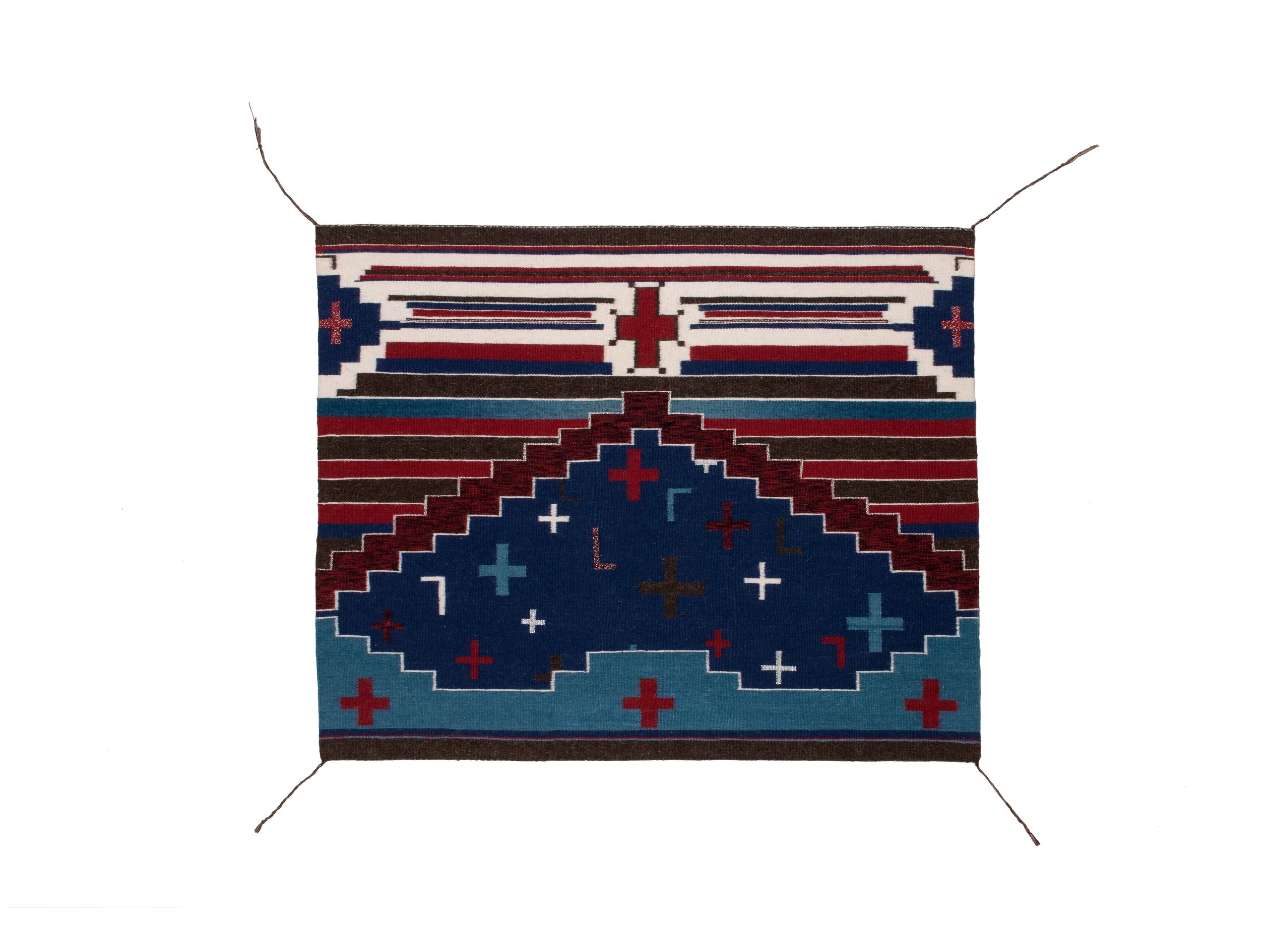 Geometric woven rug with blue and white jagged triangle patterns